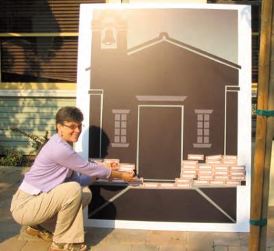 Cynthia Cottam places a pledge brick